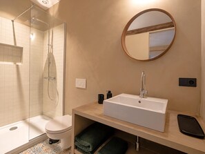 A modern bathroom with a glass-enclosed shower, a white sink, and a round mirror. - Le Sablon Retreat Private En Suite Room (Brussels)