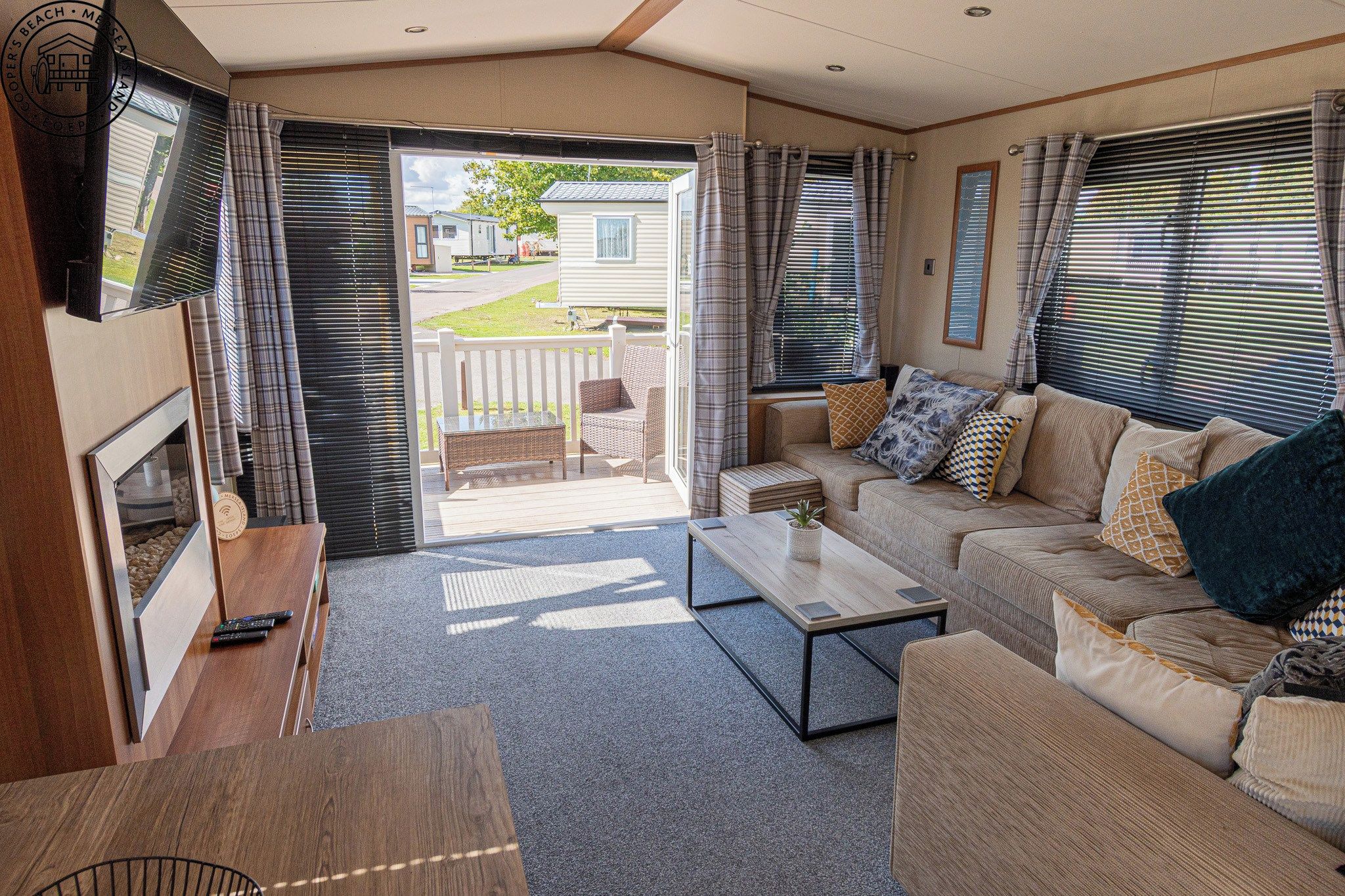 A cozy living area with a sofa set, a coffee table, and a television.