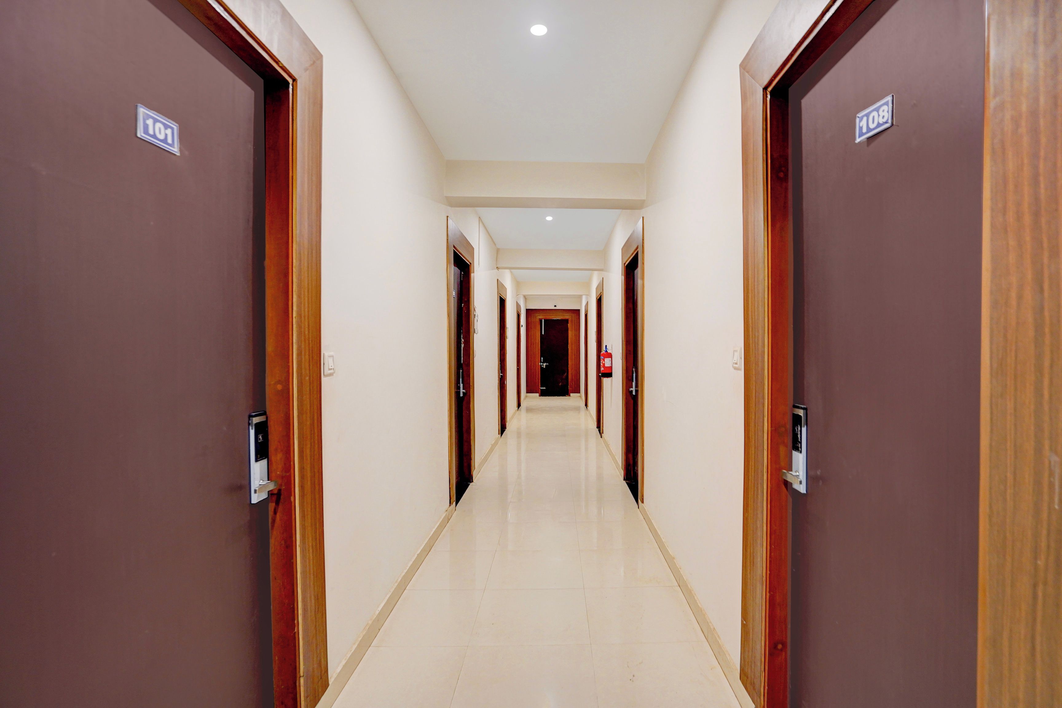 A hotel corridor with doors numbered 101 and 108, leading to rooms.