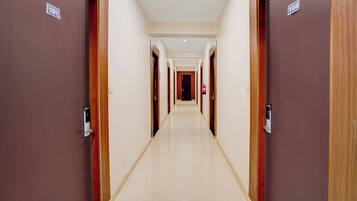 A hotel corridor with doors numbered 101 and 108, leading to rooms.