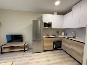 A modern kitchen with a built-in microwave, stainless steel refrigerator, and a sink. - Aires de Salamanca Melibea (Salamanca)