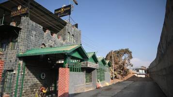 A building with a sign for 'RAJA KA BAGH A BOUTIQUE HOTEL' and 'FIRANG DHABA.'
