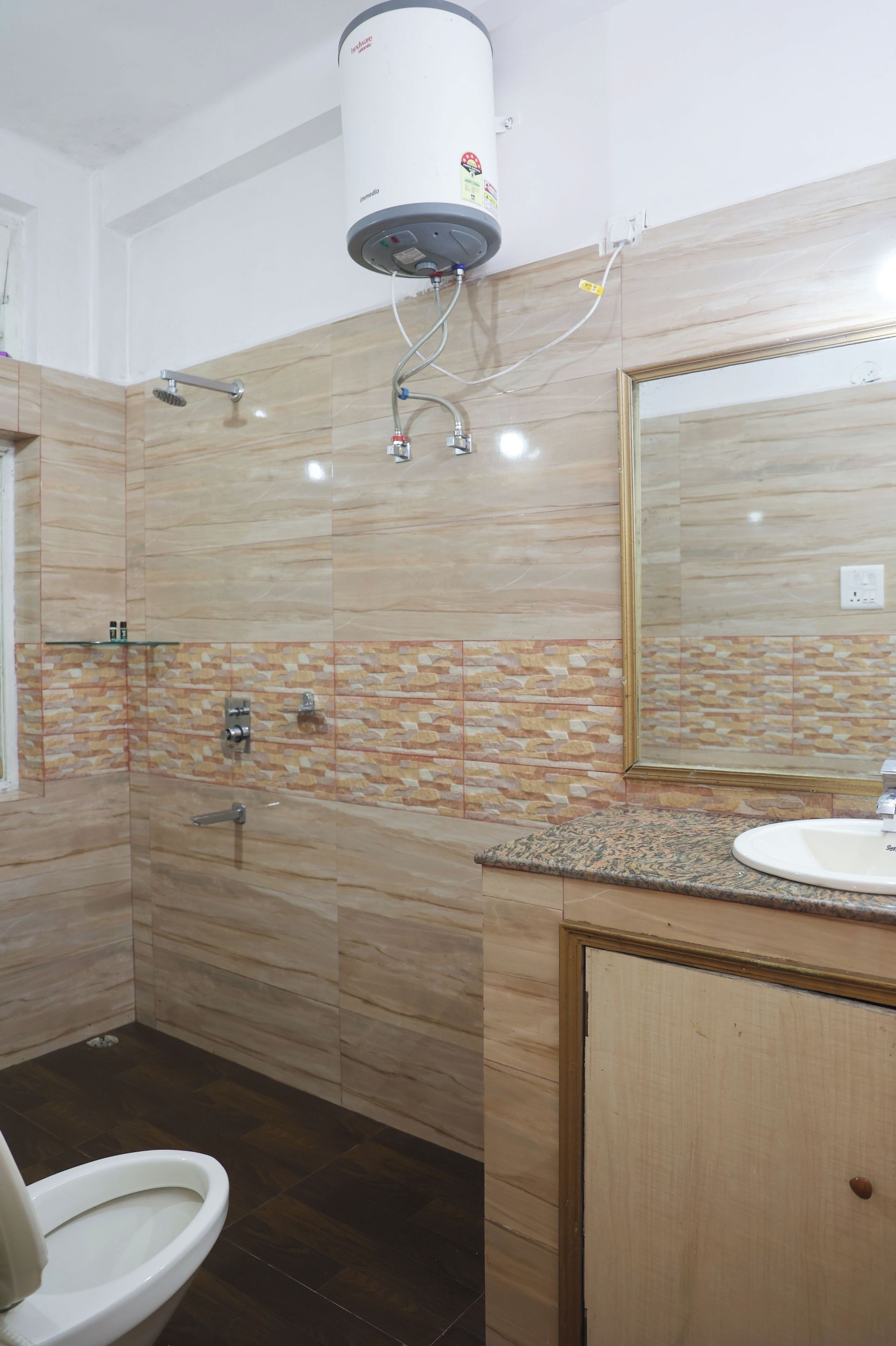 A bathroom with a toilet, sink, mirror, and shower.