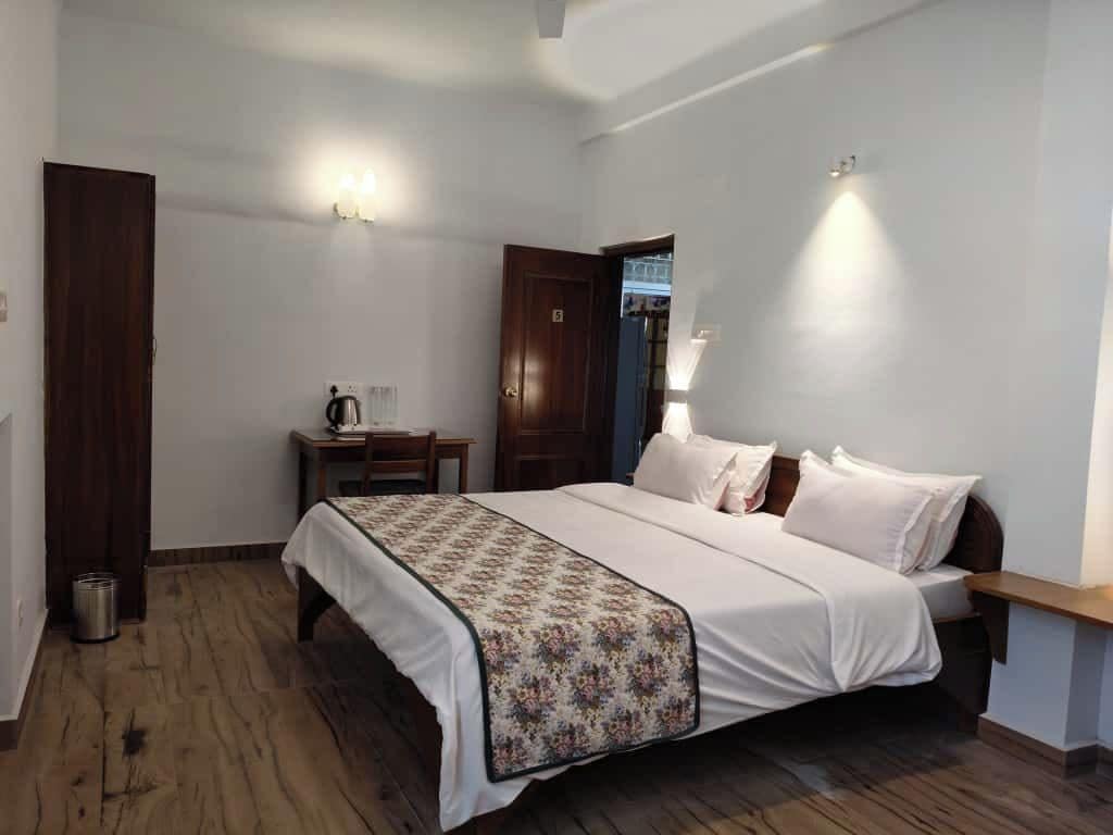 A bedroom with a bed, bedside table, and a nightstand.