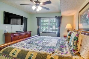 A bedroom with a bed, a ceiling fan, a window with curtains, a dresser, and a lamp. - Creek & Mountain Views, Free Tickets to Area Attractions (Gatlinburg)