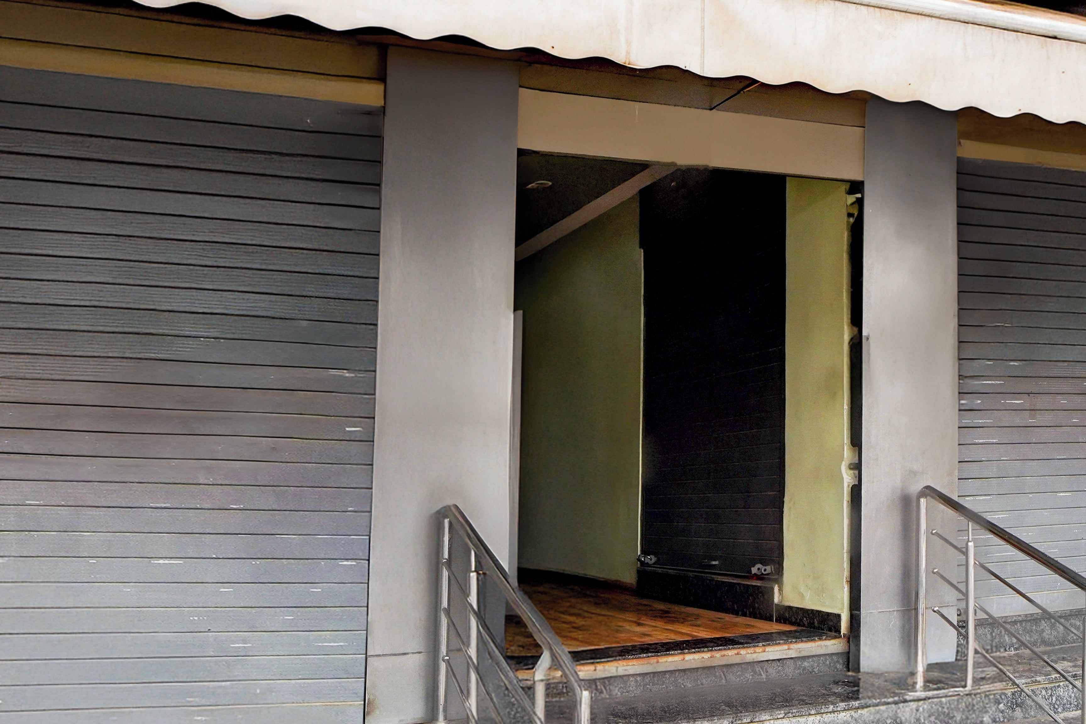A doorway with a wooden floor leading into a room with a green wall.