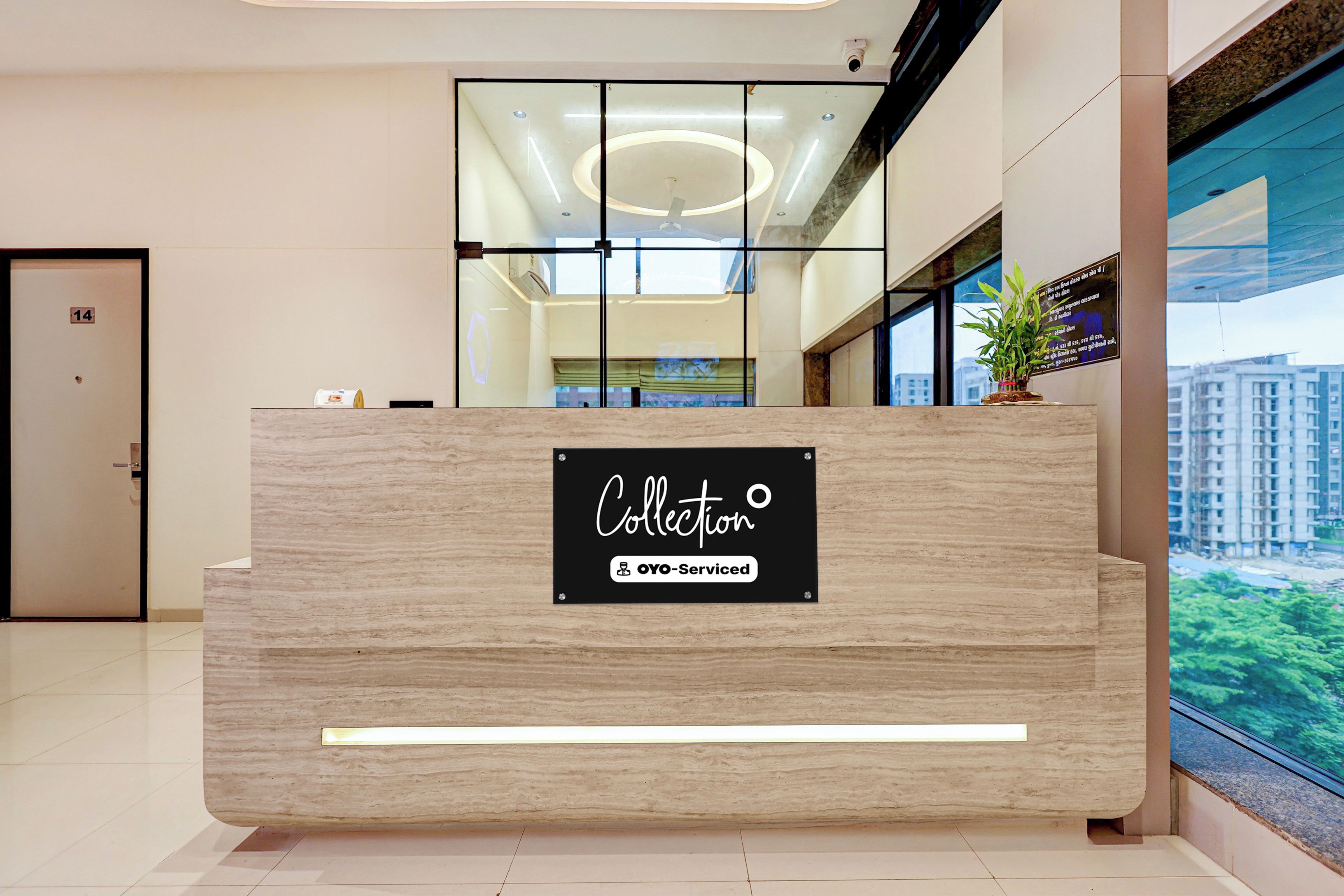 A reception desk with a sign indicating it is serviced by OYO.