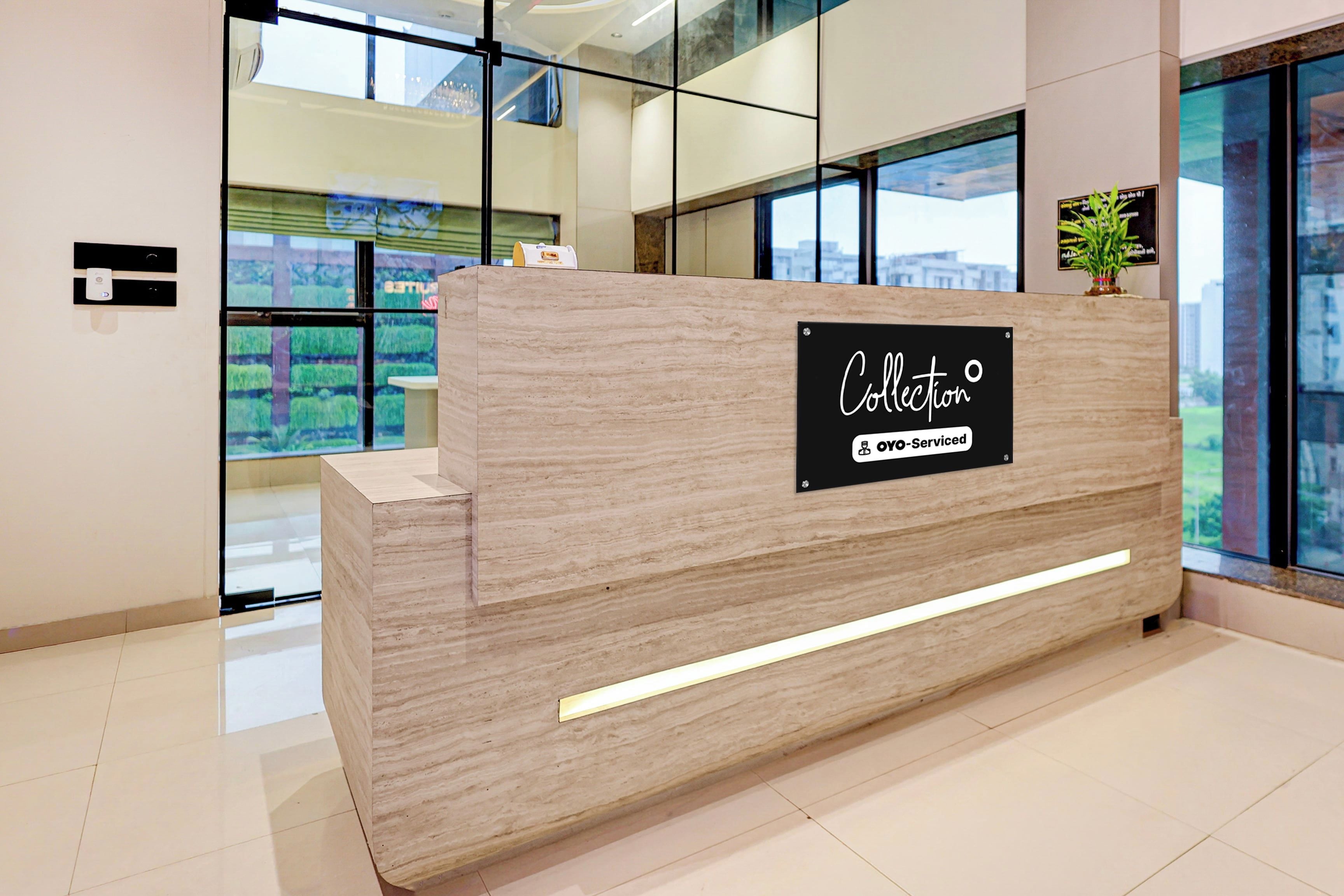 A reception desk with a sign indicating it is 'Collection' and 'YO-Serviced'.