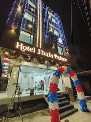 Hotel Shala Palace with illuminated signage and a decorative entrance. - Hotel Jhala Palace (Ujjain)