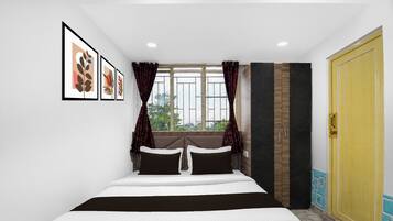 Un dormitorio con cama, ventana con cortinas, armario y cuadros en la pared.