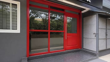 A building with a red door and a sign above it.