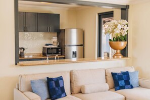A modern kitchen with a built-in microwave, refrigerator, and coffee maker. - Spacious 5BR Aruba Retreat with 2 Private Pools, Guest Apartment, 2 BBQ's & Outdoor Lounge (Noord)