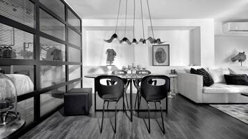Un espace repas moderne avec une cloison en verre, une table ronde et deux chaises.