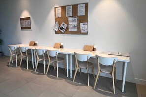 A conference room with a long table and six chairs, a bulletin board with various notices, and a potted plant. - Apartment 'Pure South' with Mediterranean Views (Manilva)