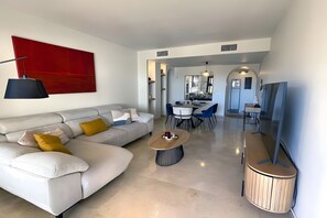 Una sala de estar moderna con un sofá, una mesa de centro y un televisor.