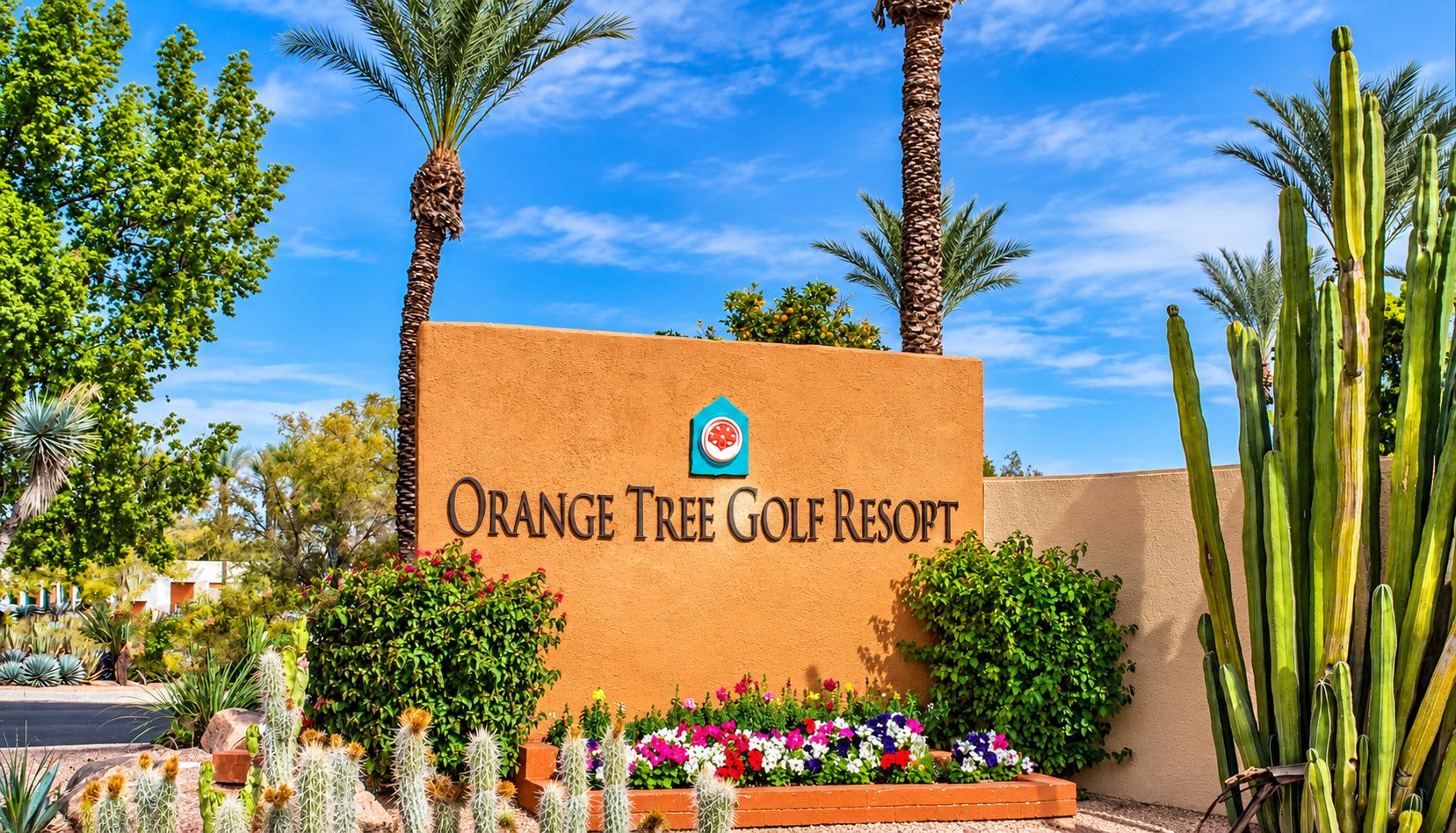 The entrance sign of Orange Tree Golf Resort with a clear sky.