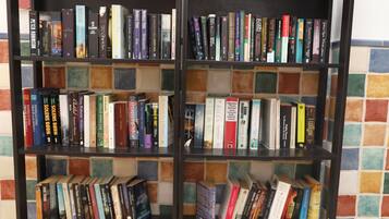 A bookshelf with a variety of books, some with visible titles and authors.