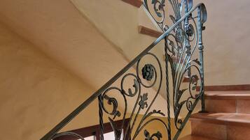 A staircase with ornate metal railings and wooden steps.