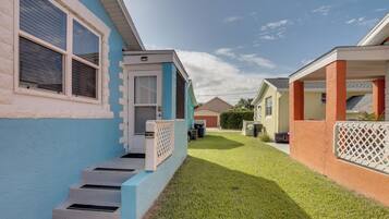 A row of single-story houses with a well-maintained lawn and a clear sky.