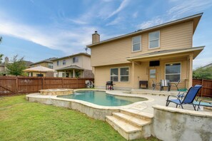 A residential backyard with a swimming pool, a patio with outdoor furniture, and a wooden fence. - 7 Mi to Seaworld! Group-friendly Getaway w/ Pool (San Antonio)