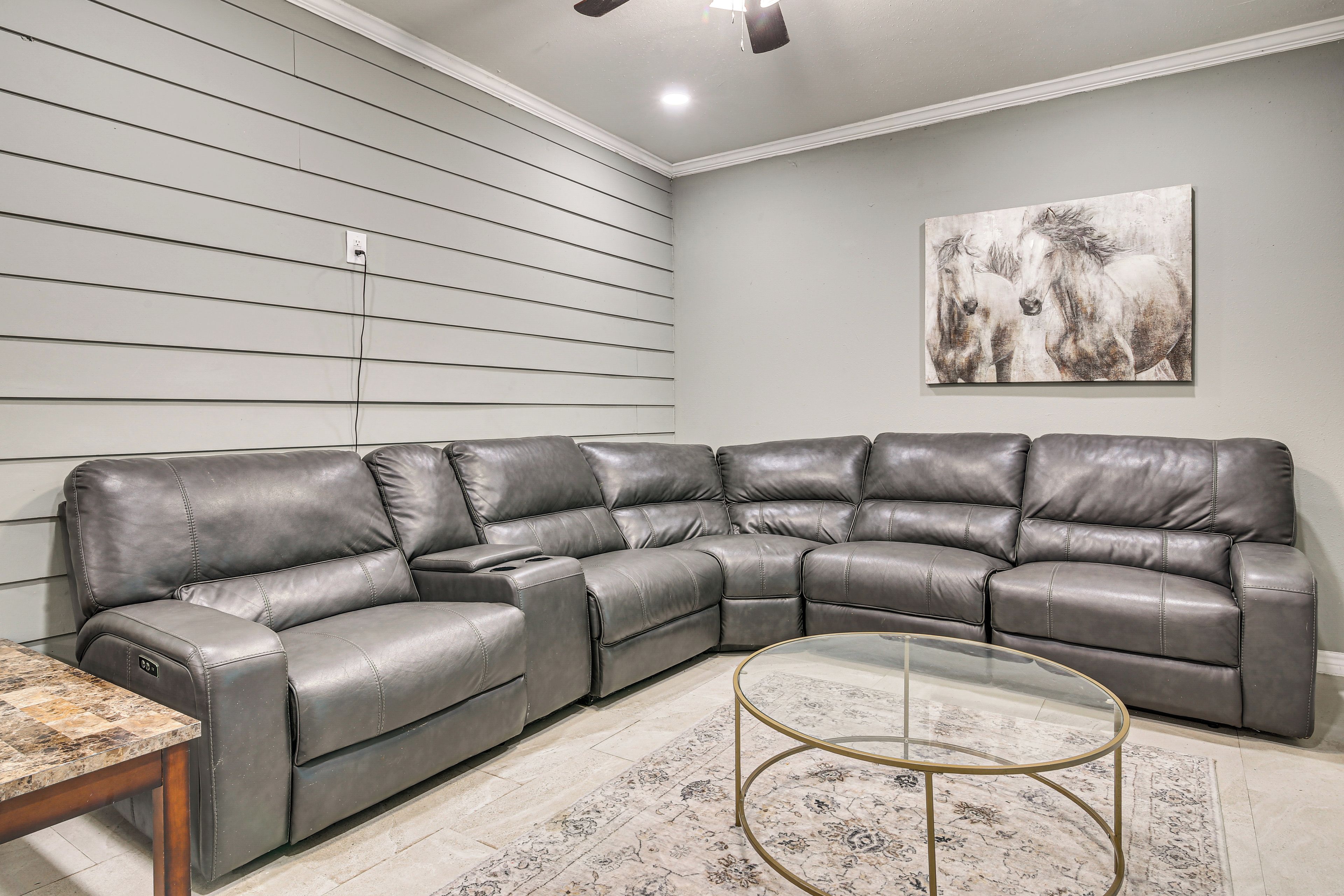 A sectional sofa with a glass coffee table in a living room.