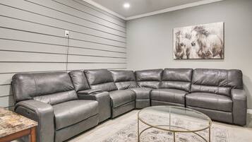 A sectional sofa with a glass coffee table in a living room.