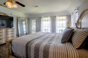 A bedroom with a large bed, a dresser, a television, and a ceiling fan. - Lakefront Family Home w/ Views & Deck in Mabank! (Mabank)
