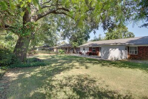 A residential area with multiple houses, a large tree, and a well-maintained lawn. - < 2 Mi to Beach! Home w/ Fenced Yard in Gulfport (Gulfport)