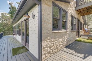 A modern house with a stone facade, large windows, and a deck with outdoor furniture. - Quiet Countryside Escape w/ Views in Talking Rock (Talking Rock)