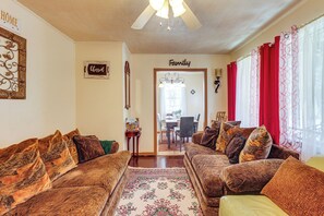 A living room with two sofas, a rug, and a dining area in the background. - Near Dtwn Jackson: Home w/ Screened Porch (Jackson)