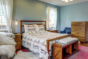 A bedroom with a wooden bed, a dresser, a chair, and a fluffy rug. - Mtn-view Ranch Near Black Canyon Nat'l Park (Crawford)