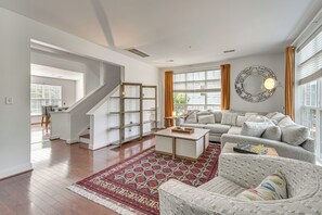 A spacious living room with a staircase, a sofa set, a coffee table, and a patterned rug. - Walden at Mechanicsburg - Walking Trails (Mechanicsburg)