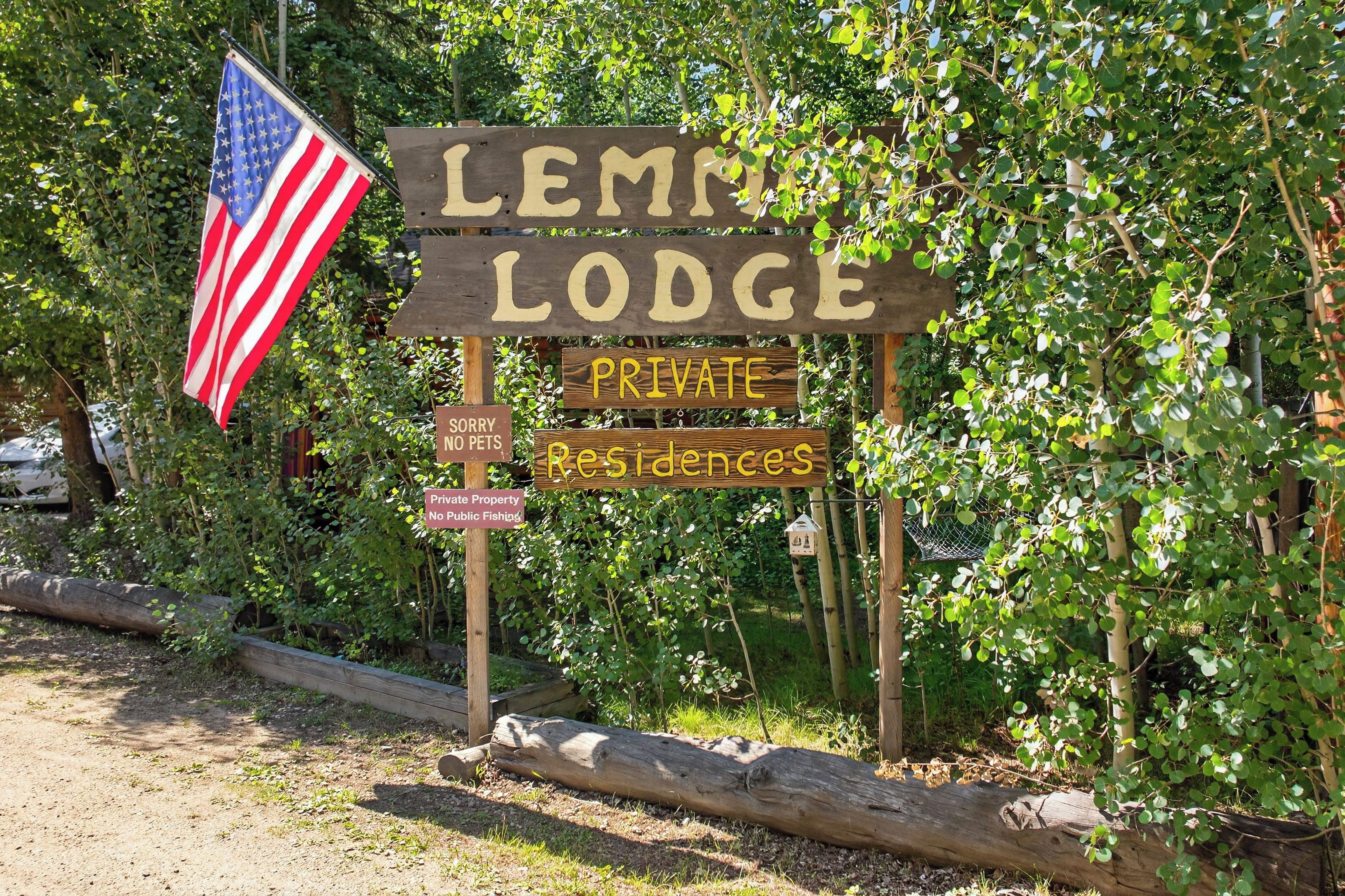 A wooden sign with 'Lemmon Lodge' and 'PRIVATE Residences' indicating a private property.