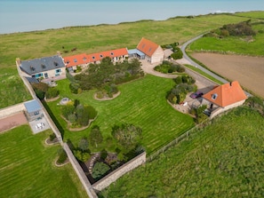 A large estate with multiple buildings, a well-maintained lawn, and a fenced property. - Cottage 'Le Four À Pain' with Private Terrace and Wi-Fi (Saint-Aubin-sur-Mer)