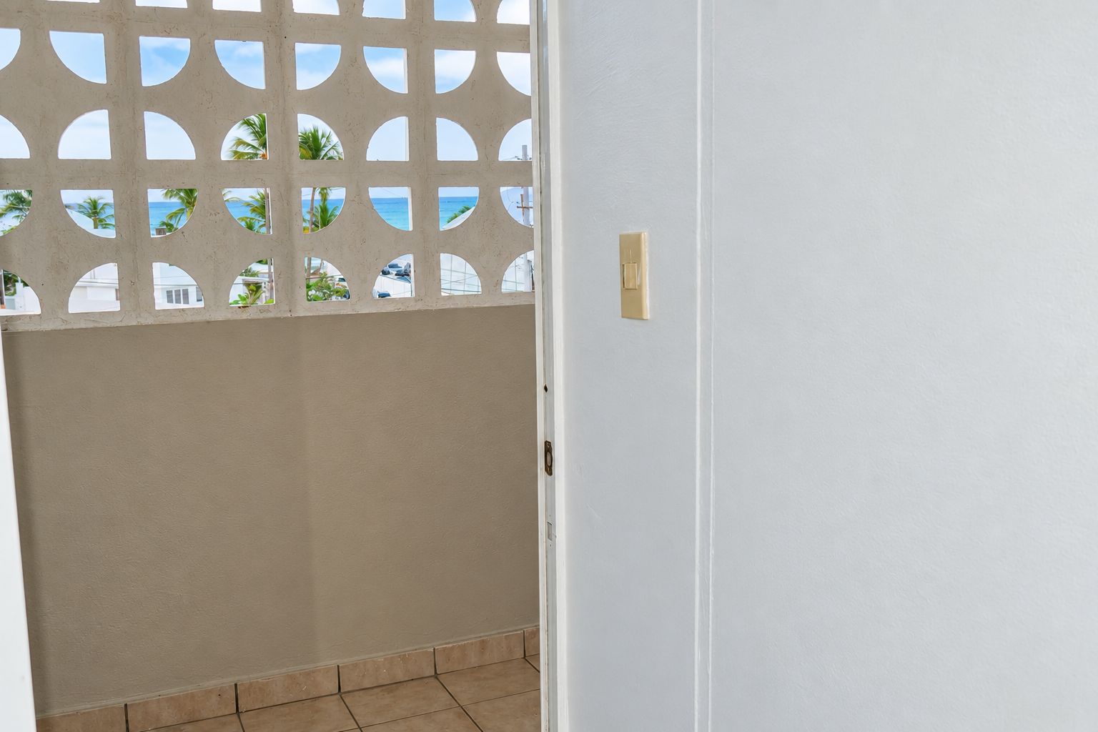 A doorway with a beige wall and a white door.