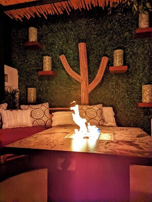 A room with a bed, a wall-mounted cactus decoration, and a textured wall. - Ocean View | Rooftop Pool | Walk to Marina/Gonzo (La Playa)