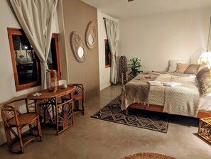 A bedroom with a bed, a desk, chairs, and a window. - Ocean View | Rooftop Pool | Walk to Marina/Gonzo (La Playa)