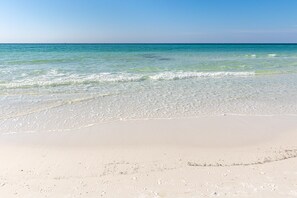 A beach with clear water and a sandy shore. - Sterling Sands 604 2 Bedroom Condo (Destin)