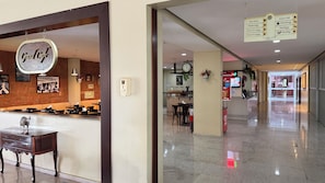 A hotel corridor with a Grand Café, a Time Share Restaurant, and a McDonald's.