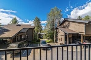 A residential area with a parking lot, a car, and a truck. - Cozy 1BR Ski Condo | Fireplace + Shuttle to Slopes (Steamboat Springs)