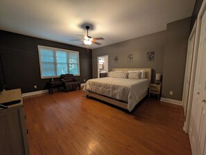 A bedroom with a bed, a chair, a desk, and a ceiling fan. - Gorgeous 4-bedroom home with pool. 5 min from Lake Murray (Lexington)