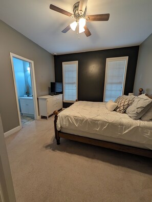 A bedroom with a bed, a desk, a ceiling fan, and two windows with blinds. - Gorgeous 4-bedroom home with pool. 5 min from Lake Murray (Lexington)