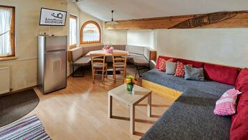 A cozy interior with a kitchenette, a dining area, and a seating area.