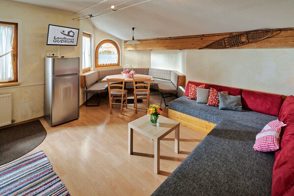 A cozy interior with a kitchenette, a dining area, and a seating area.