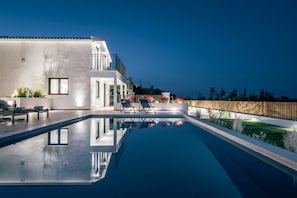 A modern house with a swimming pool, outdoor seating, and a wooden fence. - Villa Verde Zante in Kallithea (Zakynthos)