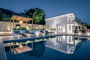 A modern outdoor pool area with lounge chairs and a pergola. - Villa Verde Zante in Kallithea (Zakynthos)