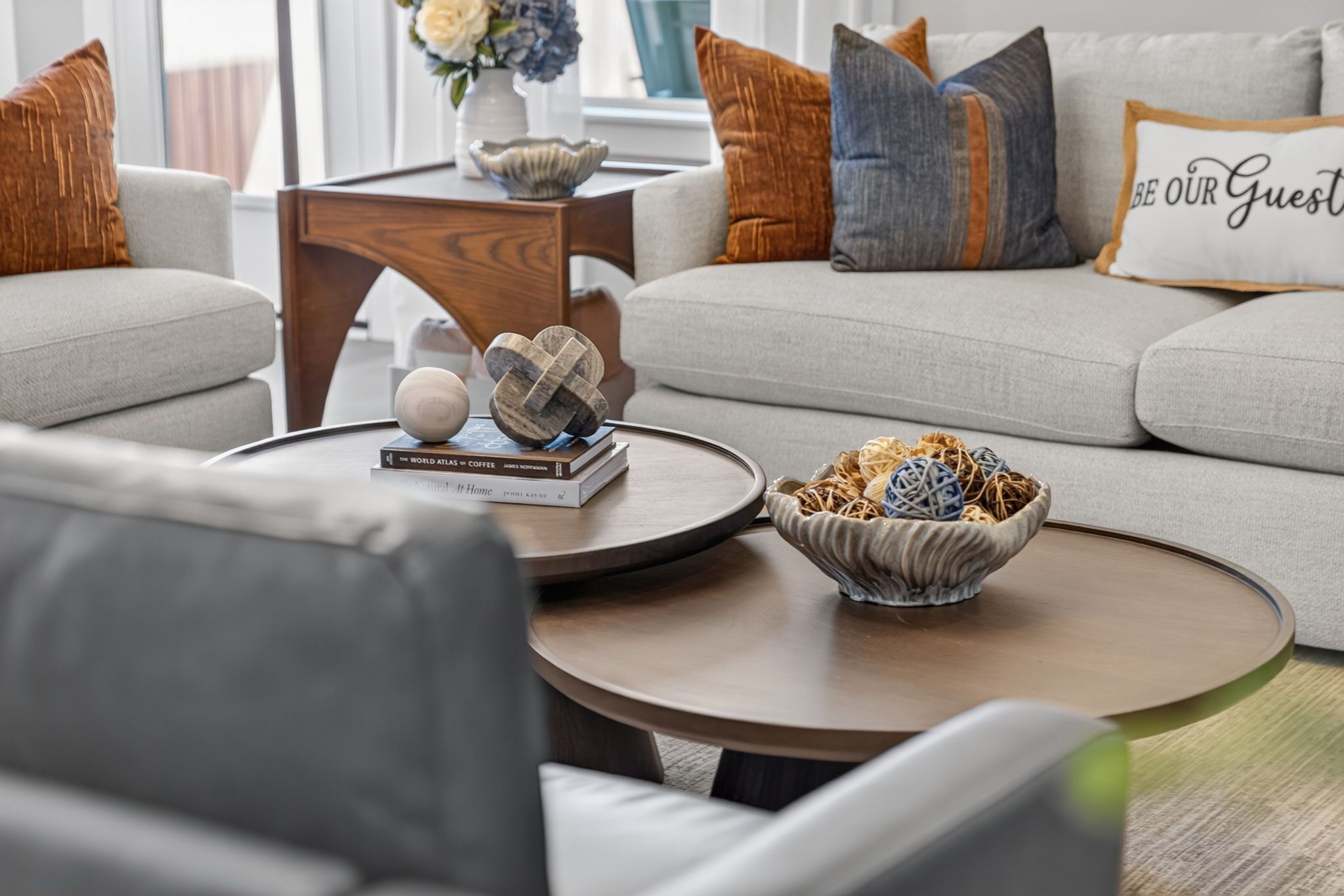 A modern living room with a sofa, coffee table, and decorative items.