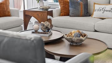 A modern living room with a sofa, coffee table, and decorative items.