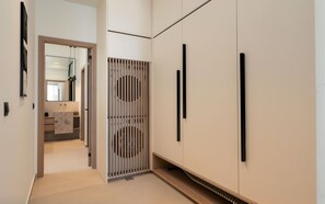 A hallway with a modern interior design, featuring a wooden floor, a mirrored wardrobe, and a built-in cabinet. - Casa Euphoria Private Pool (Schisma Elountas)