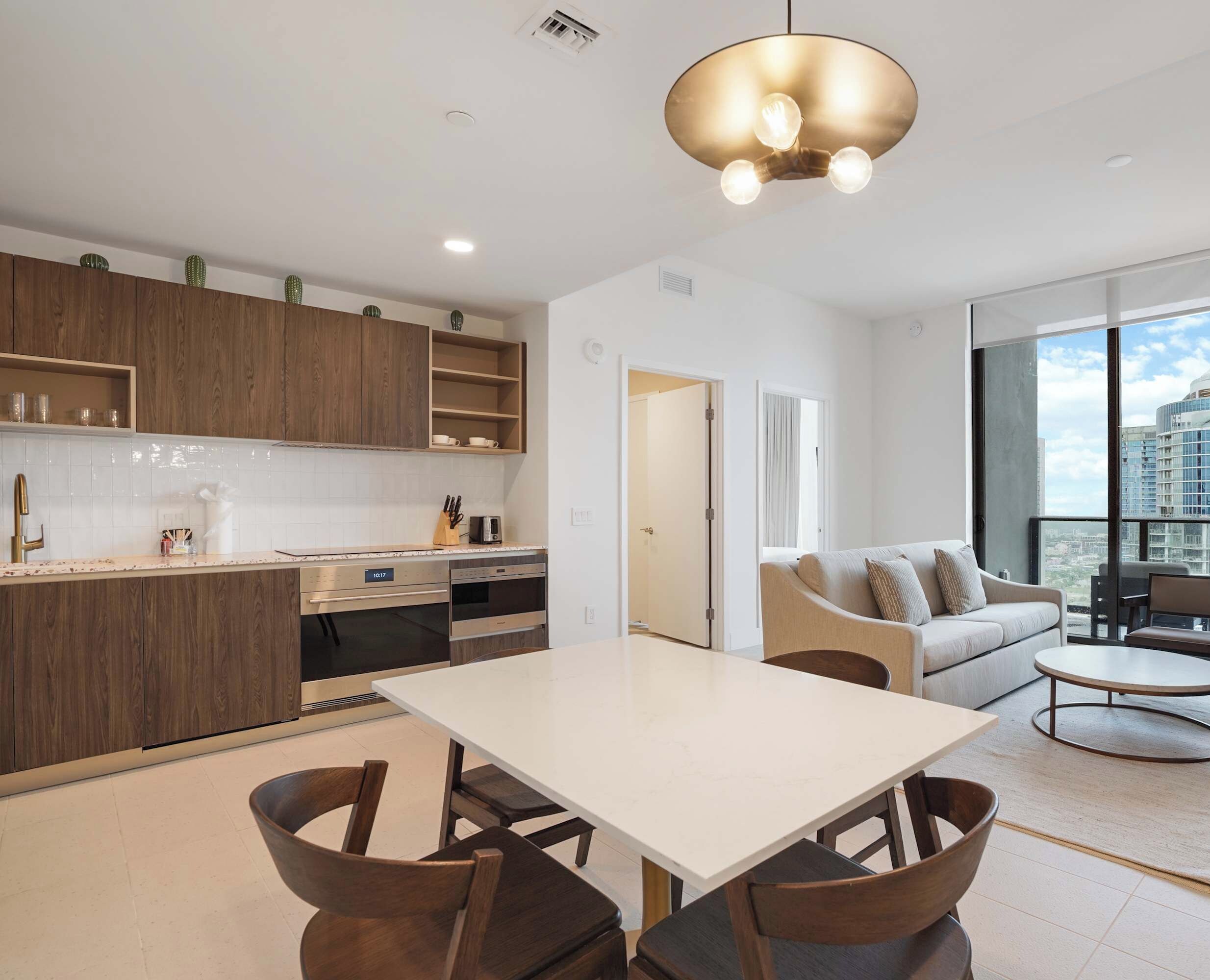 Gather around the dining table in the open living space with plenty of natural light.